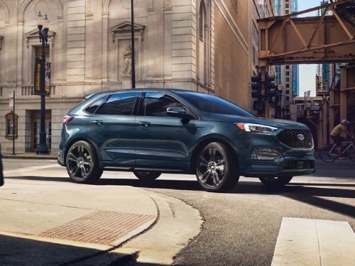 2024 Ford Edge driving around a curb in the city