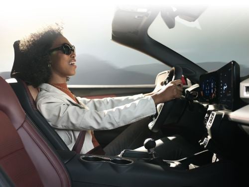 2024 Ford Mustang view of woman driving with the top of the car off