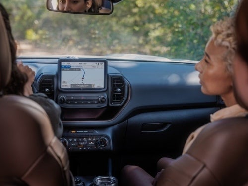 2024 Ford Bronco Sport interior view of couple in front seats on a roadtrip